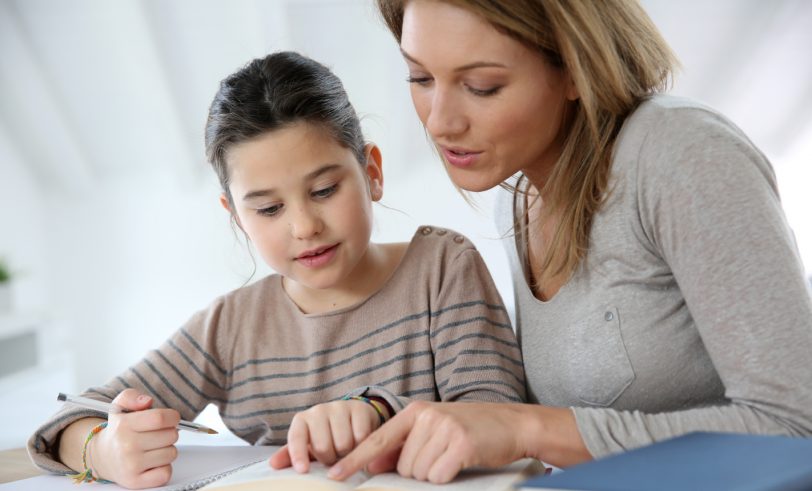 Mother helping daughter with homework